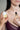 Two women in lingerie hold clean fragrance products: one holds a small round white compact solid perfume balm and the other holds a clean fragrance oil bottle labeled 'Fleurac' 
